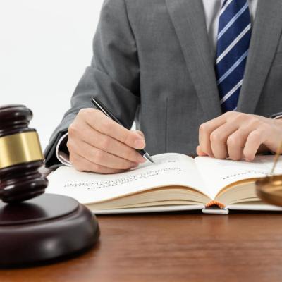 Closeup Shot Person Writing Book With Gavel Table 1